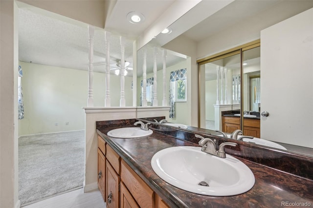 bathroom featuring vanity, a textured ceiling, ceiling fan, and tile patterned floors