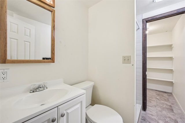 bathroom featuring vanity, toilet, and tile patterned flooring