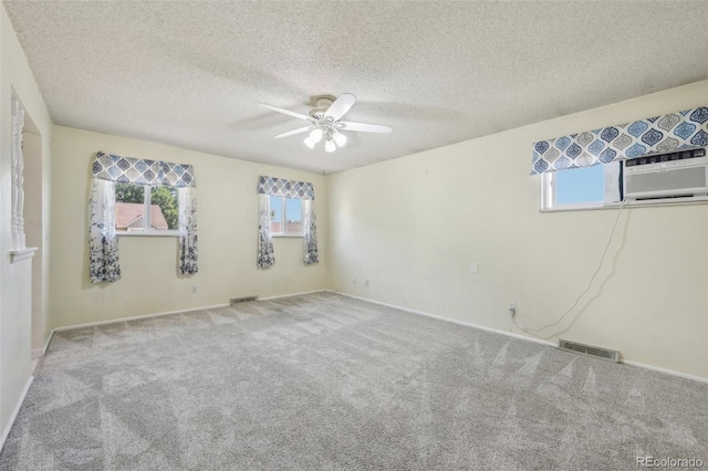 spare room with a textured ceiling, carpet flooring, and ceiling fan