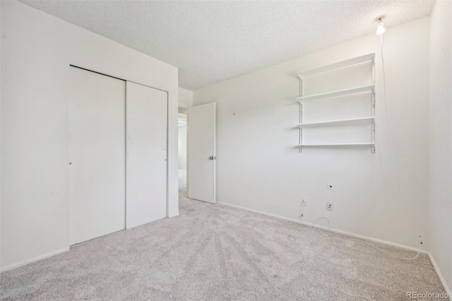 unfurnished bedroom featuring carpet flooring and a textured ceiling