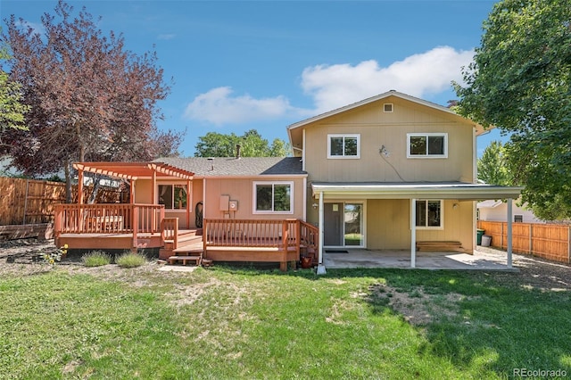 rear view of property featuring a pergola, a patio area, a deck, and a lawn