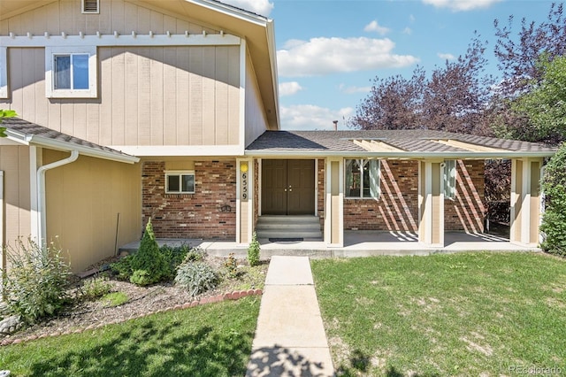 doorway to property with a yard