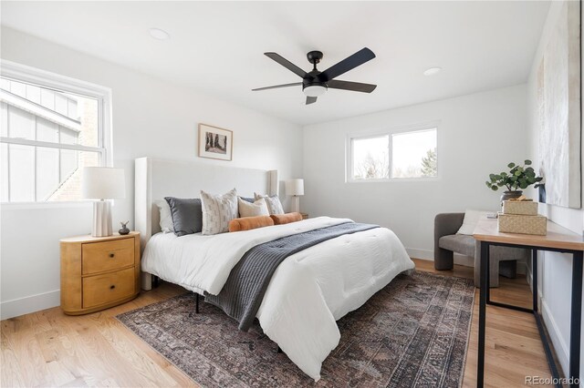 bedroom with ceiling fan and light wood-type flooring