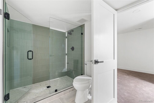 bathroom with toilet, tile patterned floors, and walk in shower