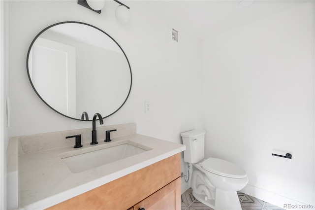 bathroom with vanity and toilet