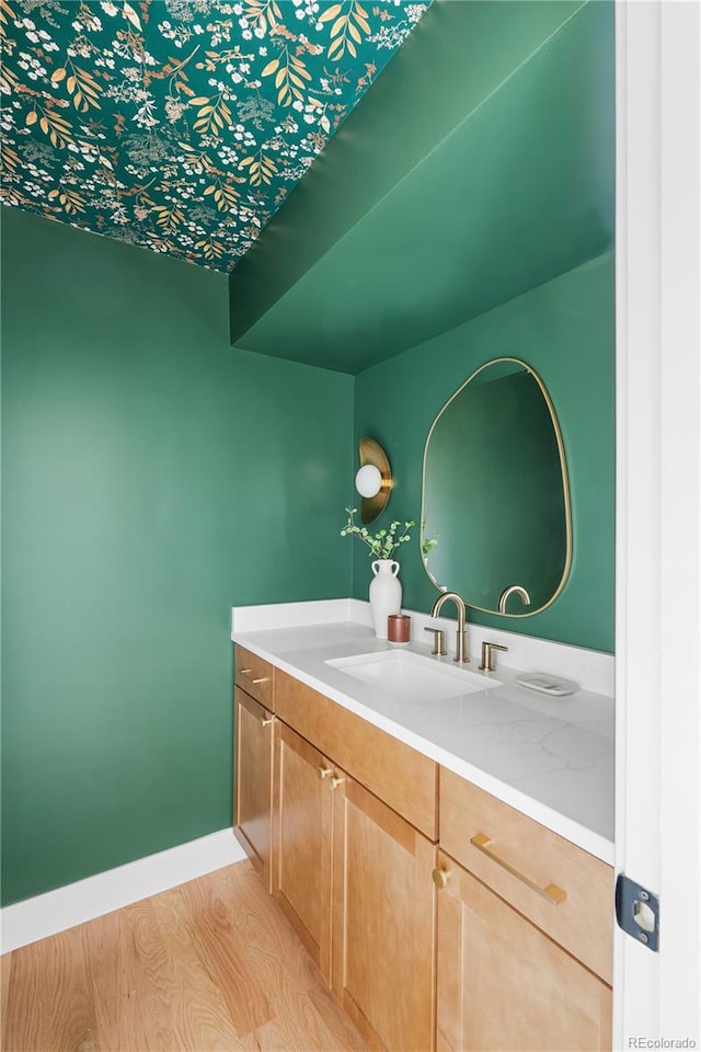 bathroom with vanity and hardwood / wood-style floors