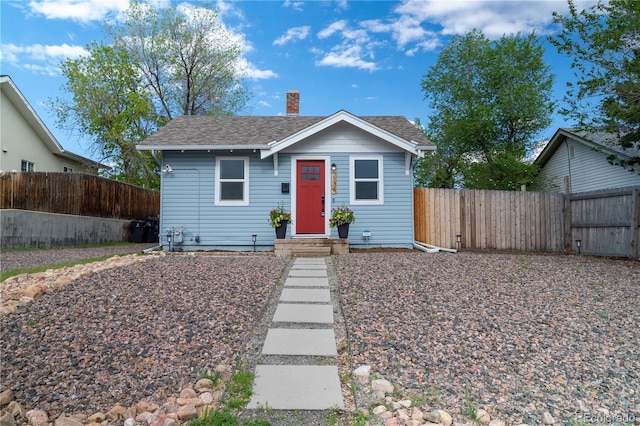134 S Quitman St, Denver, CO 80219 - bungalow with a chimney, a fenced backyard, and a shingled roof