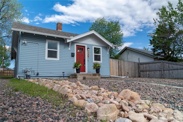 134 S Quitman St, Denver, CO 80219 - view of front facade featuring a chimney and fence