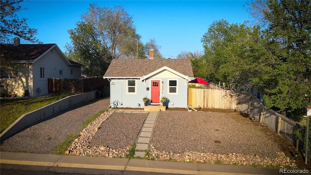 134 S Quitman St, Denver, CO 80219 - bungalow featuring a chimney, an outdoor structure, and a shingled roof