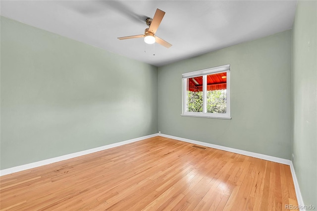 empty room with baseboards, hardwood / wood-style flooring, and ceiling fan