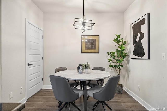 dining room featuring dark wood-type flooring and an inviting chandelier