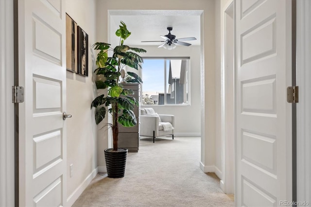 hallway featuring light carpet