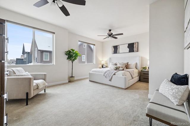 bedroom featuring light colored carpet and ceiling fan