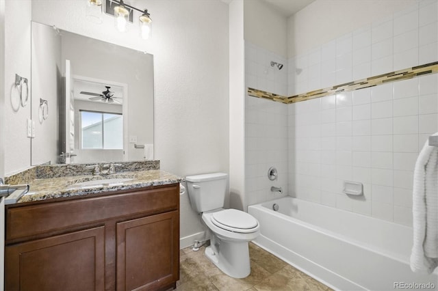 full bathroom featuring ceiling fan, tile patterned flooring, toilet, vanity, and tiled shower / bath