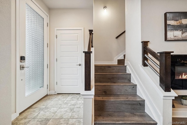 staircase featuring tile patterned flooring