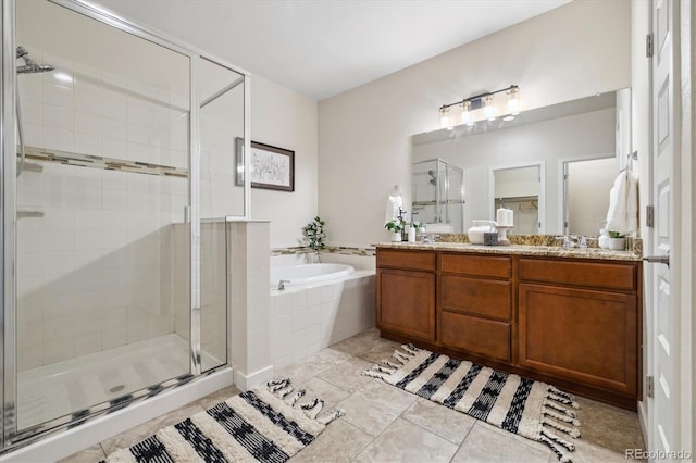 bathroom with tile patterned floors, vanity, and independent shower and bath