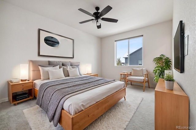 bedroom with ceiling fan and light carpet