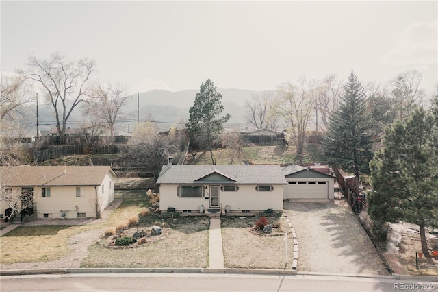 2535 W Bijou St, Colorado Springs, CO 80904 - view of front of property featuring an outdoor structure, a garage, a mountain view, and gravel driveway