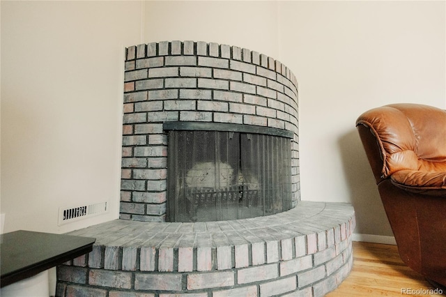 2535 W Bijou St, Colorado Springs, CO 80904 - interior details featuring a brick fireplace, baseboards, visible vents, and wood finished floors