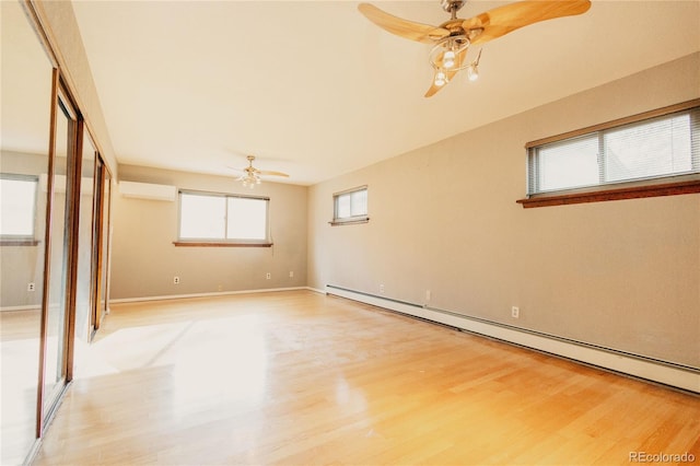2535 W Bijou St, Colorado Springs, CO 80904 - unfurnished bedroom featuring a baseboard radiator, light wood-style flooring, a wall unit AC, a ceiling fan, and baseboards