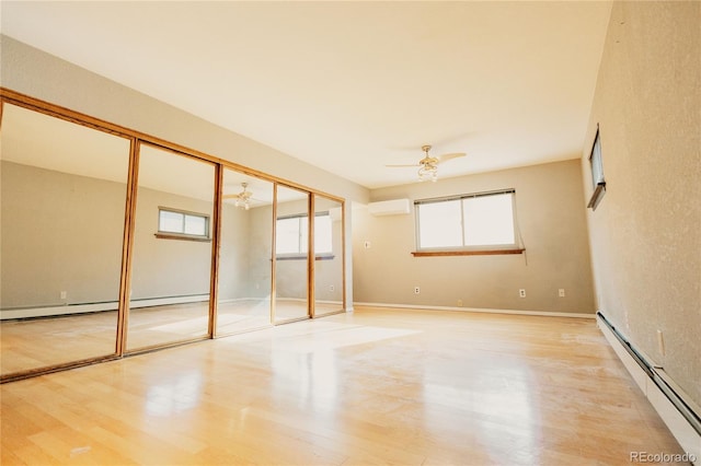 2535 W Bijou St, Colorado Springs, CO 80904 - unfurnished bedroom featuring light wood finished floors, baseboard heating, and a wall mounted air conditioner