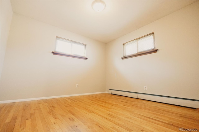 2535 W Bijou St, Colorado Springs, CO 80904 - unfurnished room featuring plenty of natural light, baseboards, light wood-style flooring, and a baseboard radiator