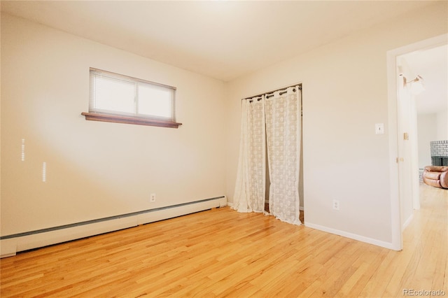 2535 W Bijou St, Colorado Springs, CO 80904 - unfurnished room with wood finished floors, baseboards, and a baseboard heating unit