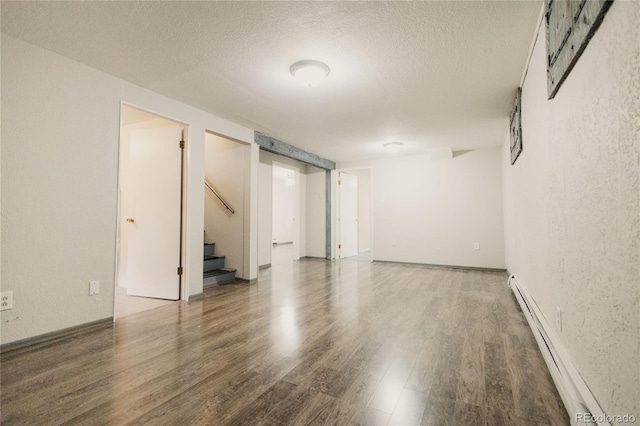 2535 W Bijou St, Colorado Springs, CO 80904 - interior space with a textured ceiling, stairway, wood finished floors, and a baseboard heating unit