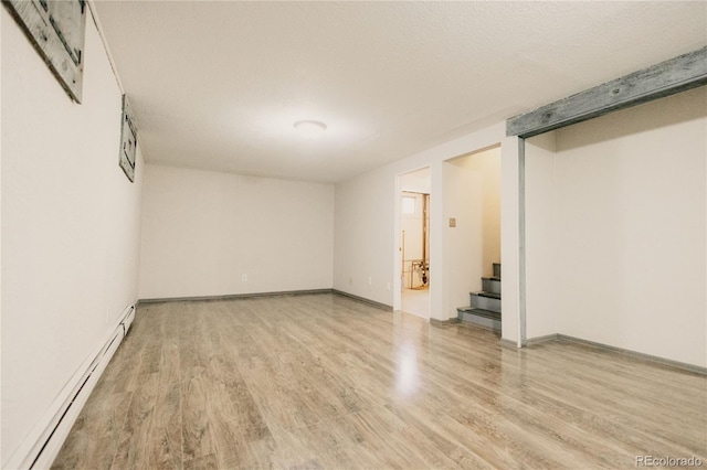 2535 W Bijou St, Colorado Springs, CO 80904 - interior space featuring light wood-type flooring, baseboards, a baseboard radiator, and stairs