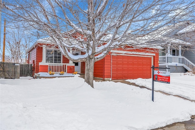 exterior space with an attached garage and fence