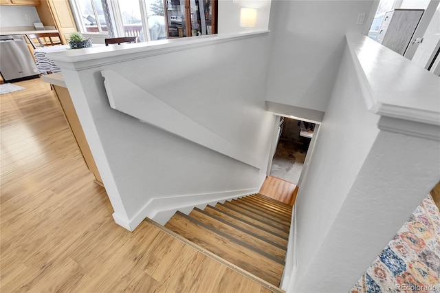 stairs with baseboards and wood finished floors