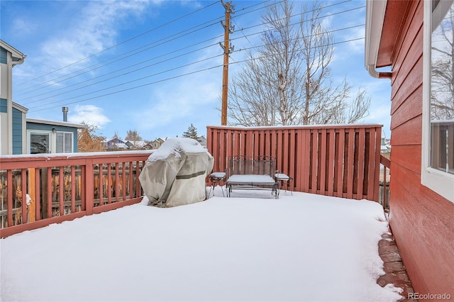 snow covered deck featuring grilling area