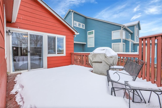 snow covered deck with area for grilling