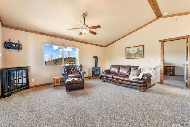 631 County Road 61, Cripple Creek, CO 80813 - living room with a wood stove, a ceiling fan, carpet flooring, vaulted ceiling, and baseboards