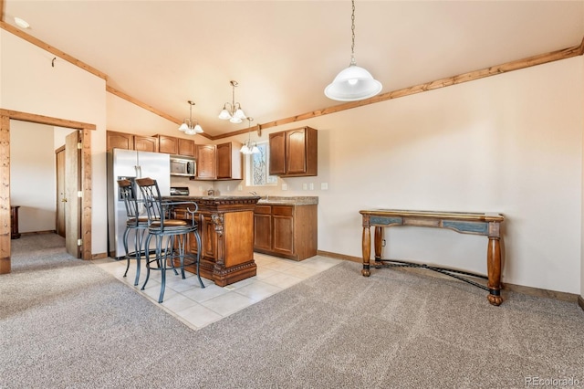 631 County Road 61, Cripple Creek, CO 80813 - kitchen featuring stainless steel appliances, vaulted ceiling, light colored carpet, a kitchen breakfast bar, and brown cabinetry