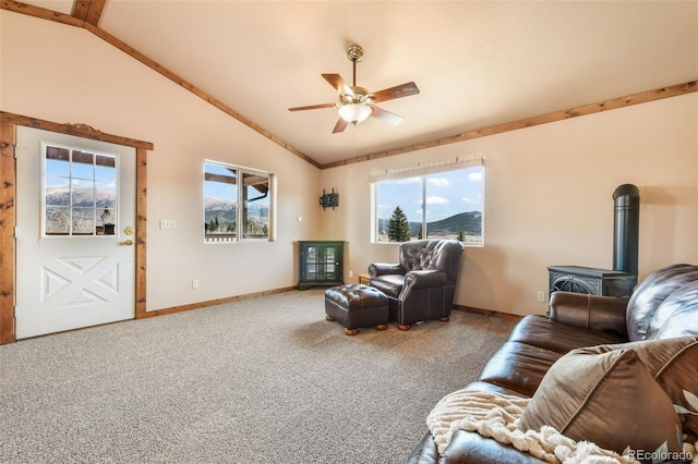 631 County Road 61, Cripple Creek, CO 80813 - living room featuring a wood stove, lofted ceiling, ceiling fan, baseboards, and plenty of natural light