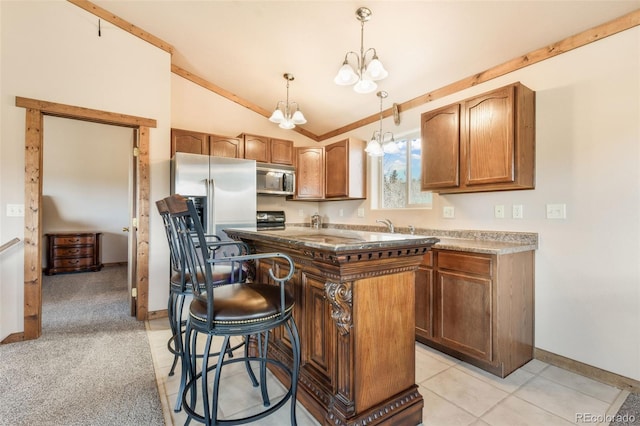 631 County Road 61, Cripple Creek, CO 80813 - kitchen with appliances with stainless steel finishes, lofted ceiling, baseboards, a chandelier, and a breakfast bar