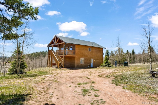 631 County Road 61, Cripple Creek, CO 80813 - back of property with stairs and a wooden deck