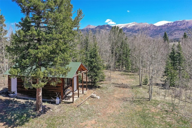 631 County Road 61, Cripple Creek, CO 80813 - view of yard with a mountain view, a view of trees, and an outbuilding