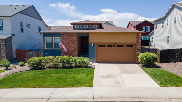 6932 E 133rd Ave, Thornton, CO 80602 - view of front of property with a garage, driveway, roof with shingles, and stone siding
