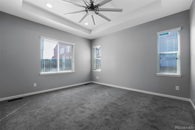 6932 E 133rd Ave, Thornton, CO 80602 - unfurnished room featuring a raised ceiling, dark carpet, recessed lighting, and a ceiling fan