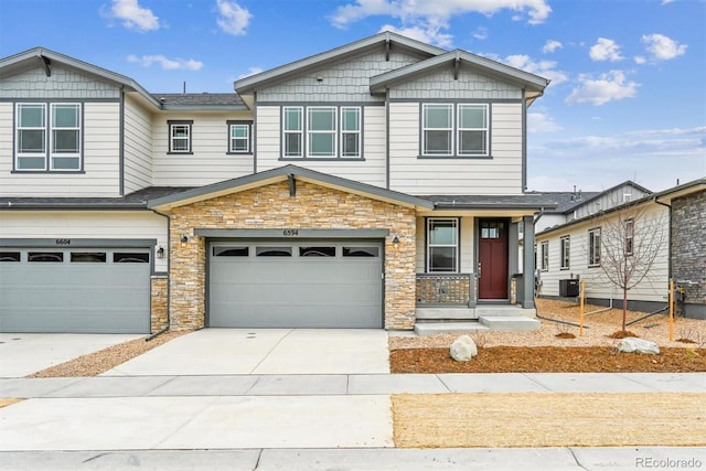 view of front of house featuring a garage and central air condition unit