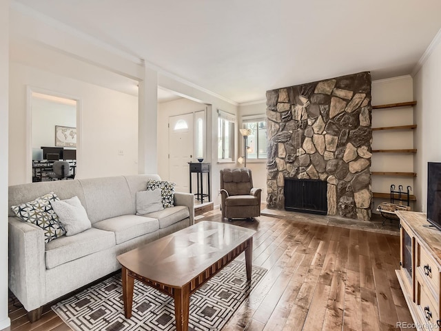 13645 E Yale Ave Unit C, Aurora, CO 80014 - living room featuring hardwood / wood-style floors, crown molding, and a stone fireplace