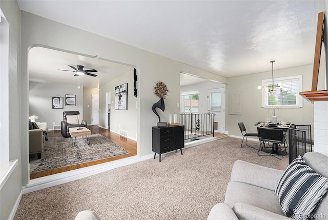 6513 Gray St, Arvada, CO 80003 - carpeted living room featuring a chandelier and ceiling fan