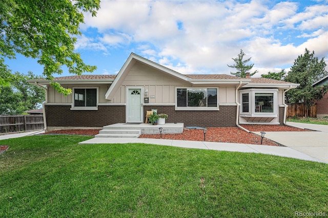 6513 Gray St, Arvada, CO 80003 - view of front of property with board and batten siding, brick siding, and a shingled roof