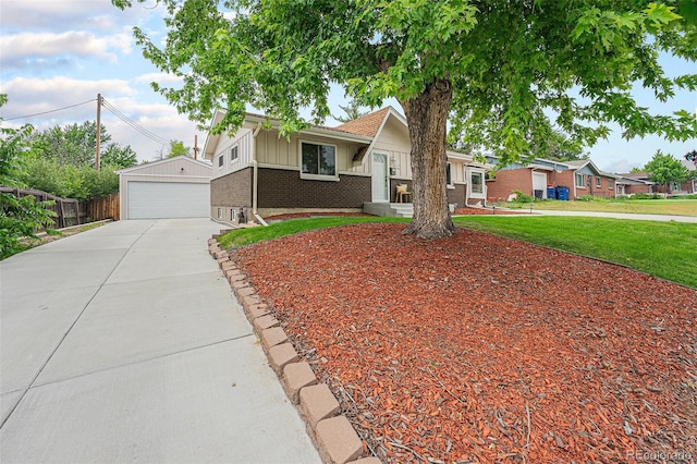 6513 Gray St, Arvada, CO 80003 - view of front facade with a garage, brick siding, board and batten siding, and an outdoor structure