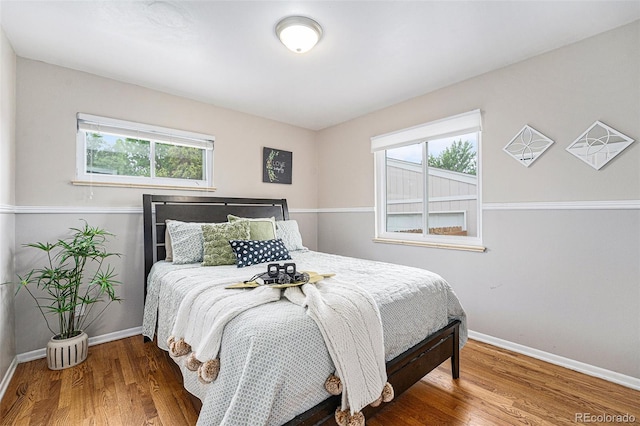6513 Gray St, Arvada, CO 80003 - bedroom with multiple windows and wood finished floors