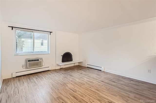 unfurnished living room featuring a baseboard radiator, ornamental molding, a wall unit AC, and hardwood / wood-style floors