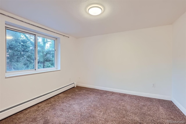 spare room featuring carpet and baseboard heating