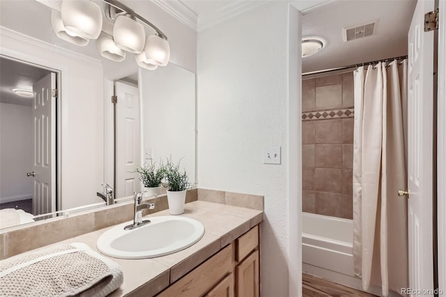 bathroom with crown molding, vanity, hardwood / wood-style floors, and shower / bath combo with shower curtain